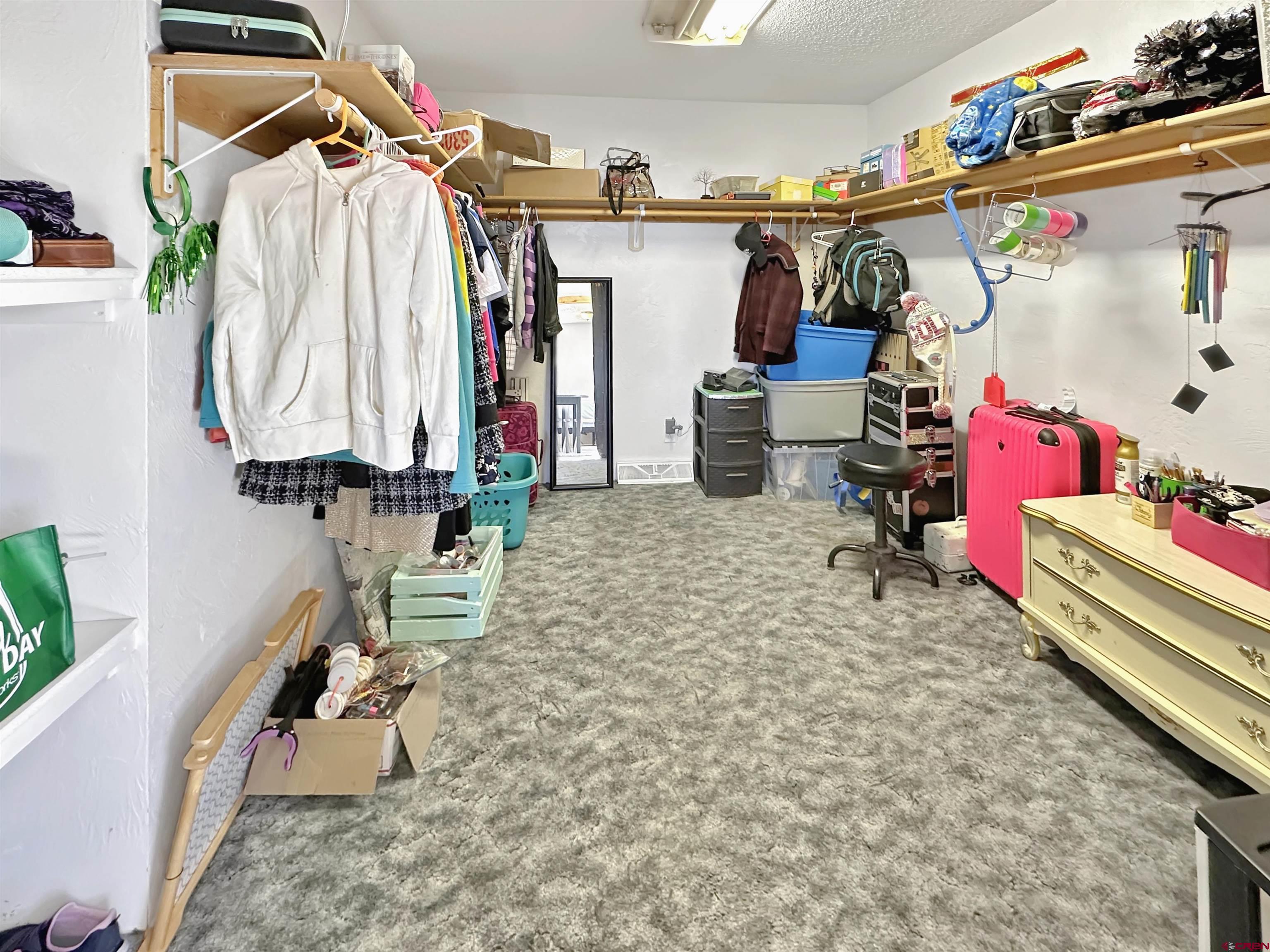 27980 Rd T Dolores, CO 81323 - Photo 20 of 29 a view of walk in closet with clothes and shoes