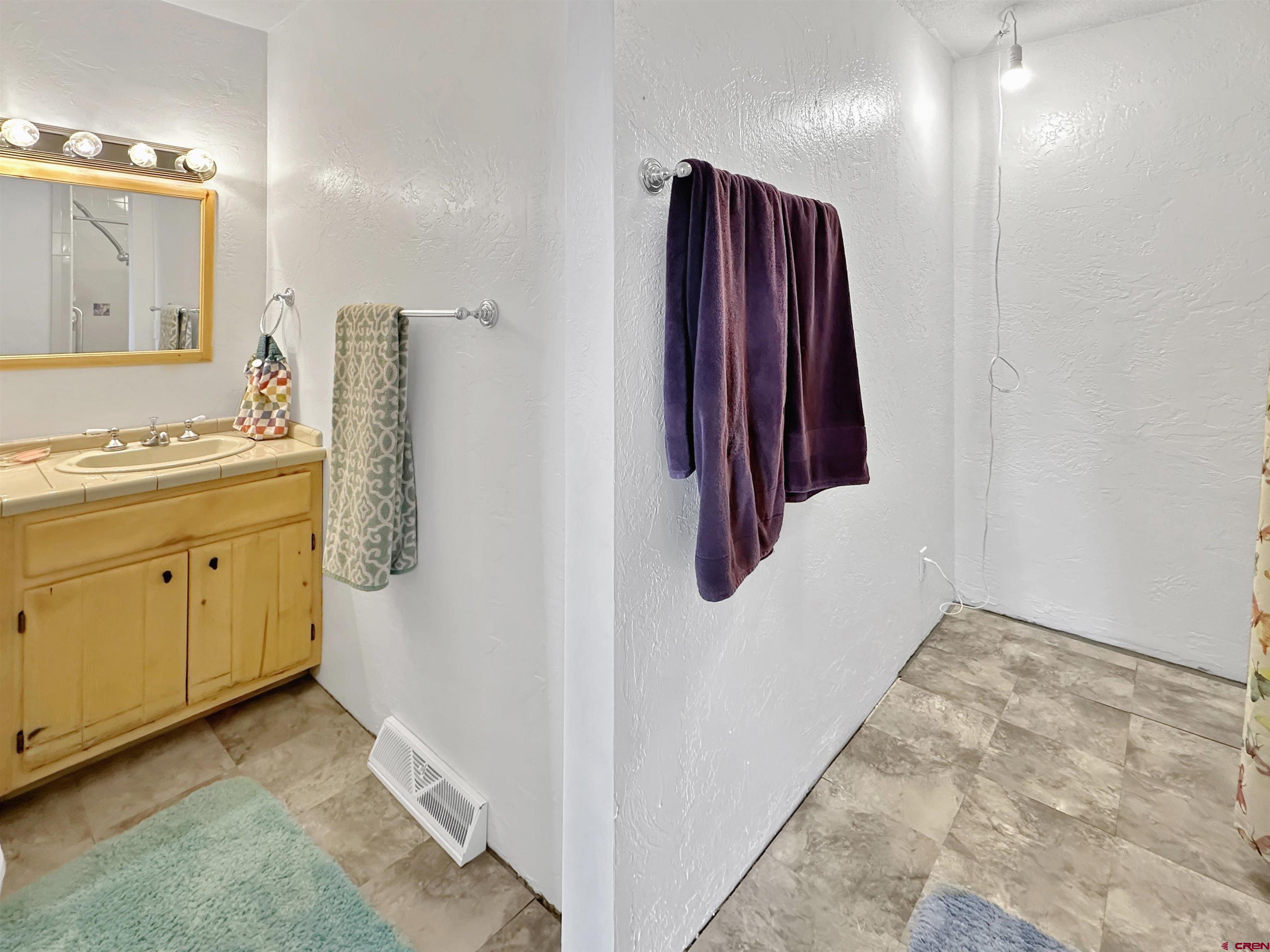 27980 Rd T Dolores, CO 81323 - Photo 21 of 29 a view of a bathroom with a sink and a mirror