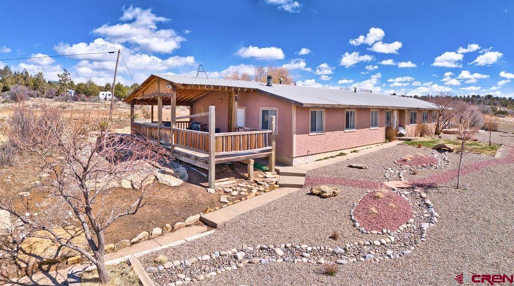 27980 Rd T Dolores, CO 81323 - Photo 26 of 29 a front view of a house with a yard and garage