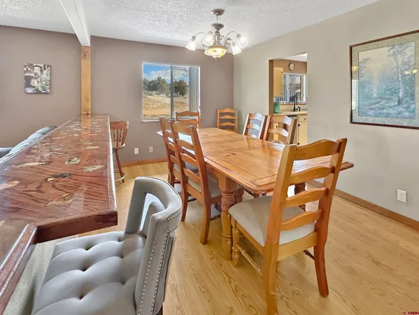 a view of a dining room with furniture and a chandelier
