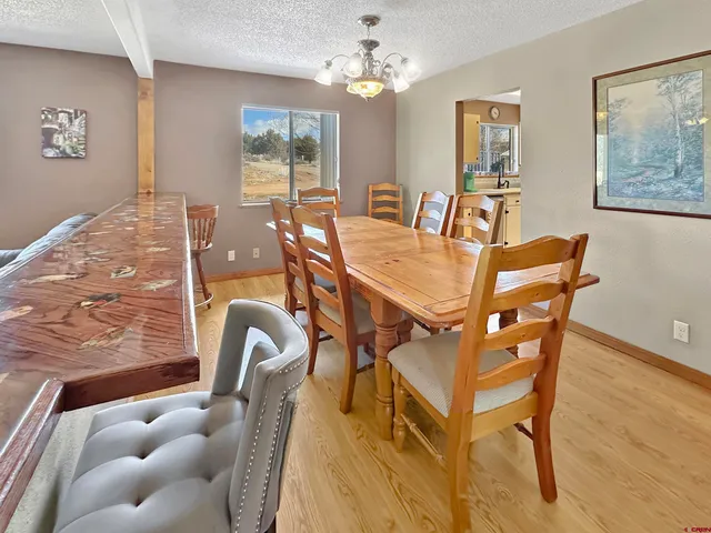 a view of a dining room with furniture and a chandelier
