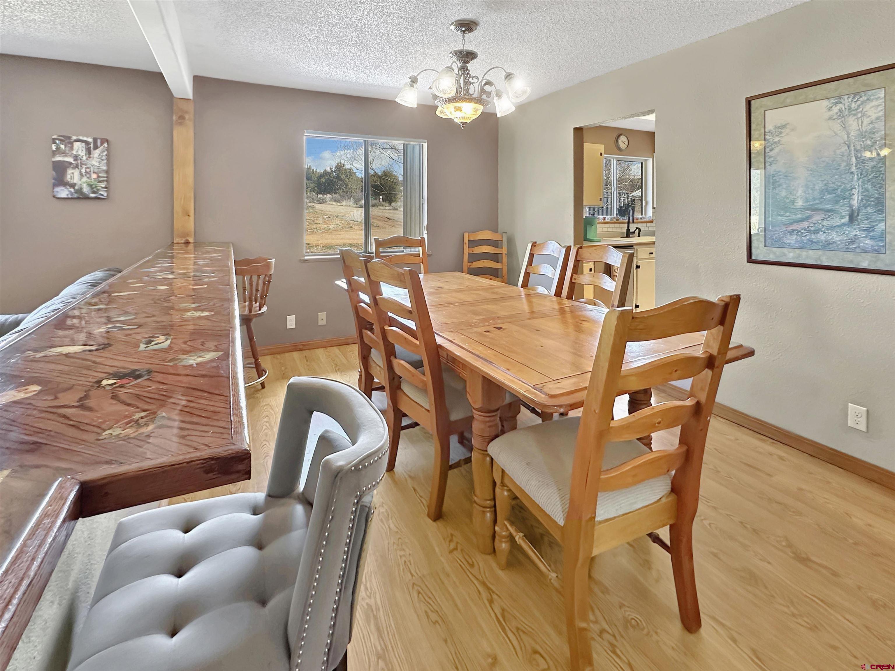 27980 Rd T Dolores, CO 81323 - Photo 5 of 29 a view of a dining room with furniture and a chandelier