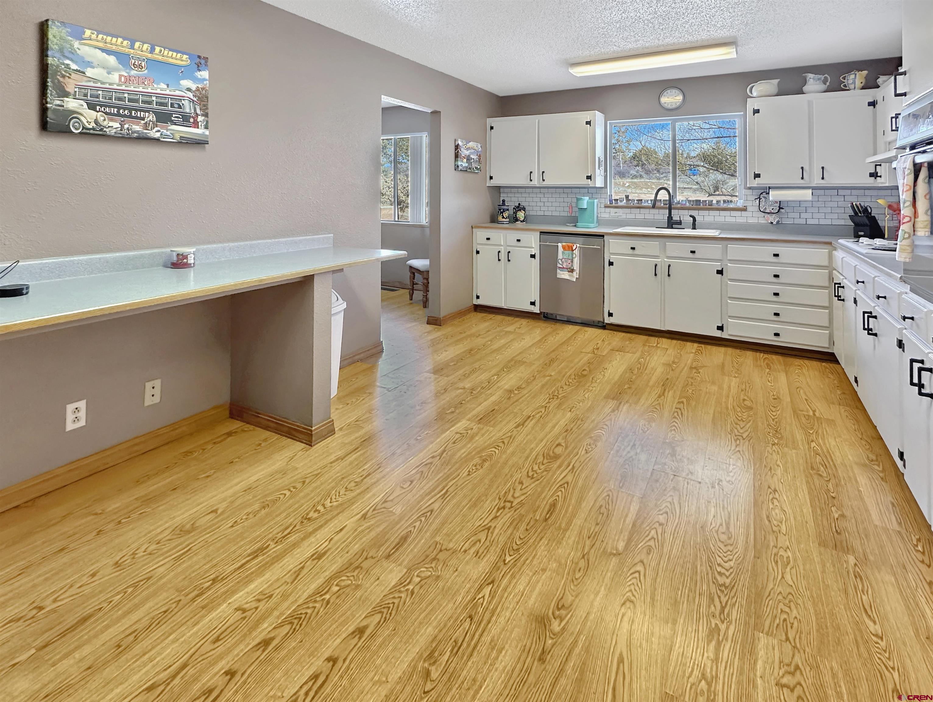 27980 Rd T Dolores, CO 81323 - Photo 6 of 29 a large kitchen with stainless steel appliances wooden floors and view living room