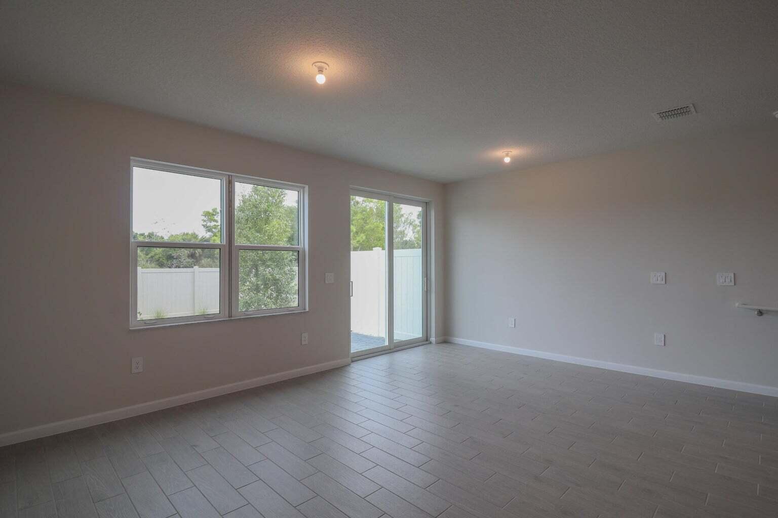 357 Southeast Angler Drive Stuart, FL 34994 - Photo 11 of 25 an empty room with wooden floor and windows