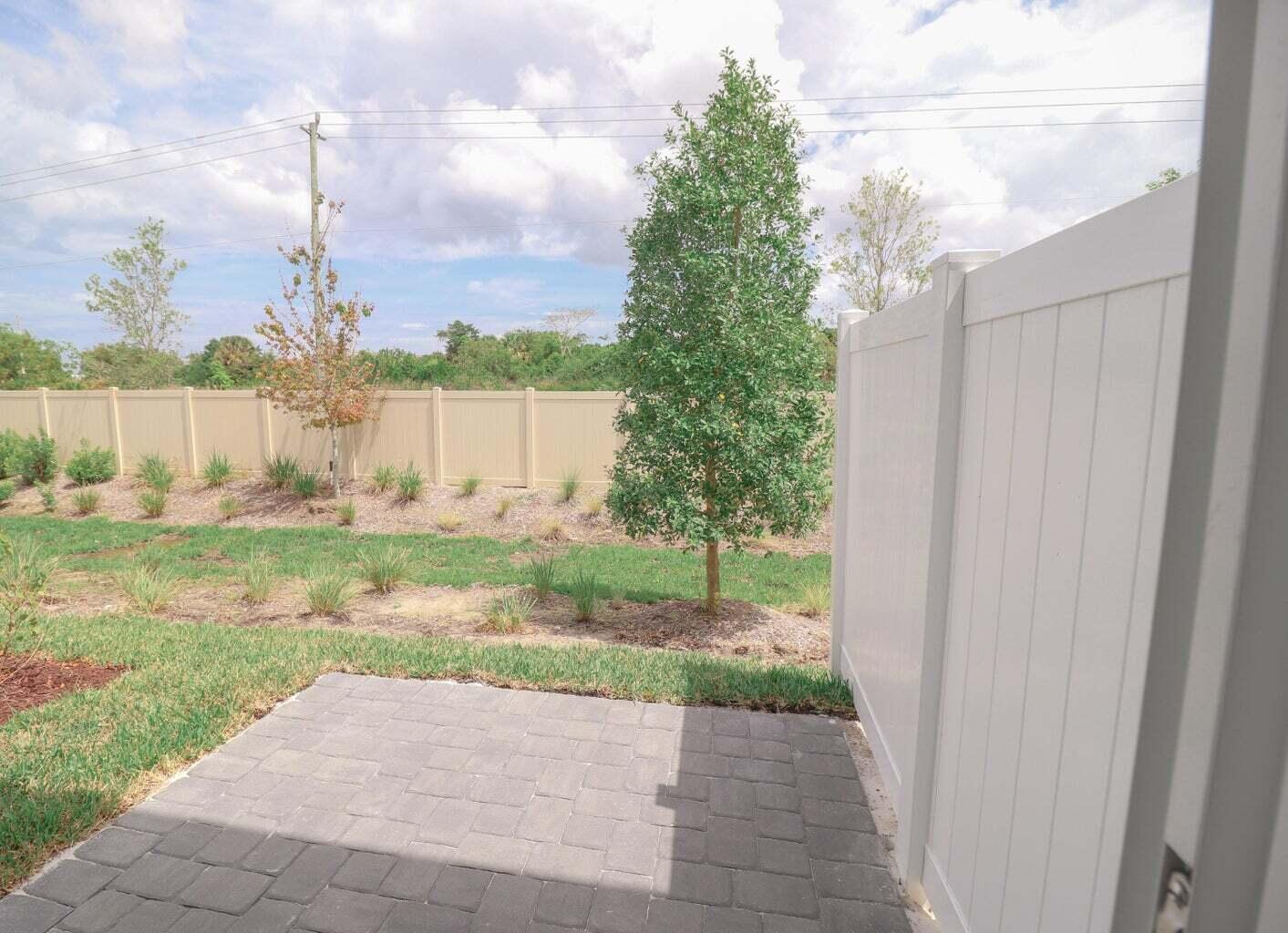 357 Southeast Angler Drive Stuart, FL 34994 - Photo 14 of 25 a view of a yard with flower plants and wooden fence