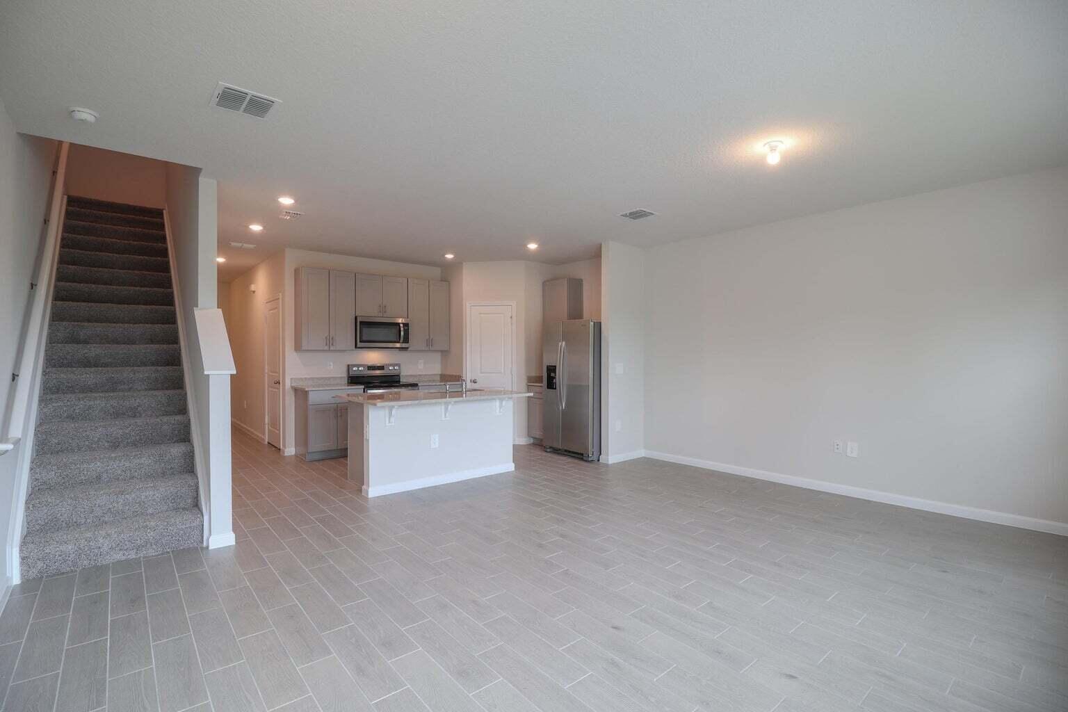 357 Southeast Angler Drive Stuart, FL 34994 - Photo 15 of 25 a view of kitchen with kitchen island white cabinets and stainless steel appliances