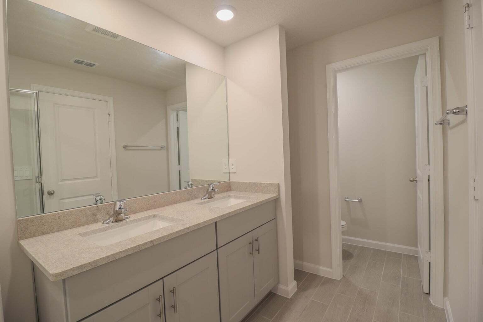 357 Southeast Angler Drive Stuart, FL 34994 - Photo 18 of 25 a bathroom with a sink and a mirror