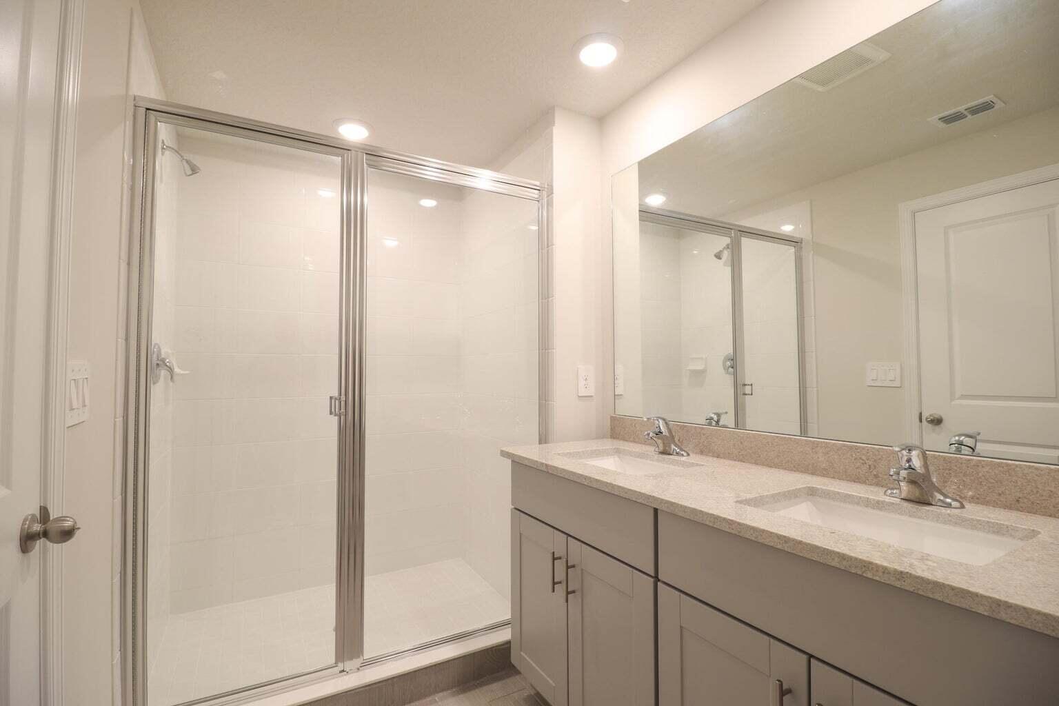 357 Southeast Angler Drive Stuart, FL 34994 - Photo 20 of 25 a bathroom with double sink and a mirror