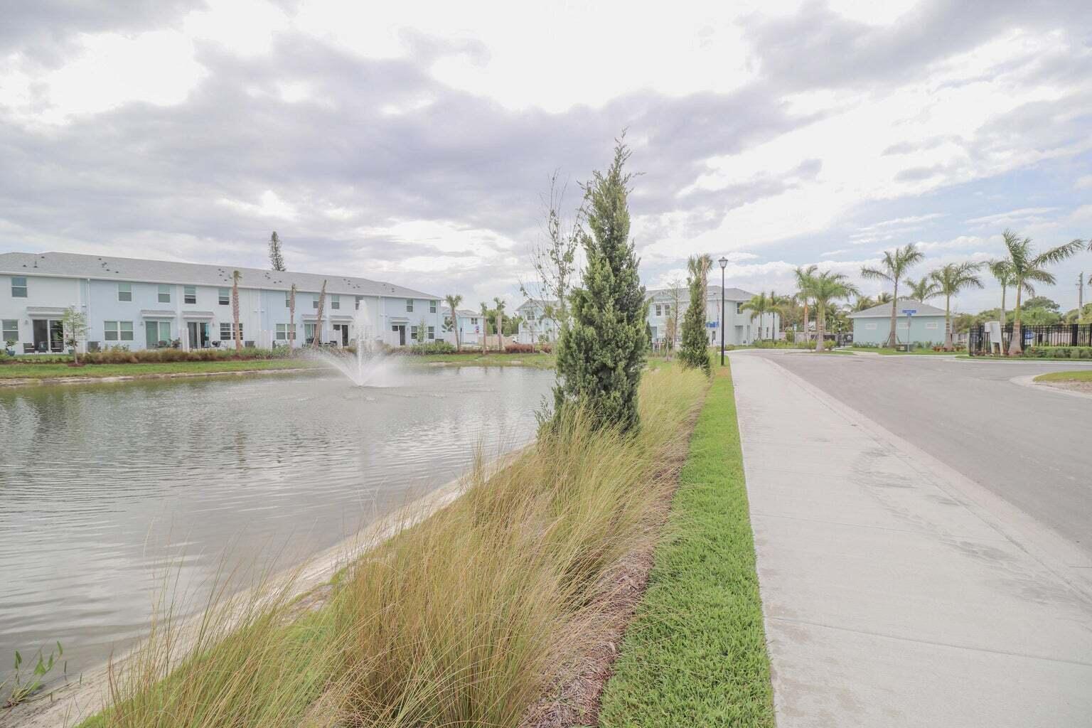 357 Southeast Angler Drive Stuart, FL 34994 - Photo 23 of 25 a view of a lake with houses in the back