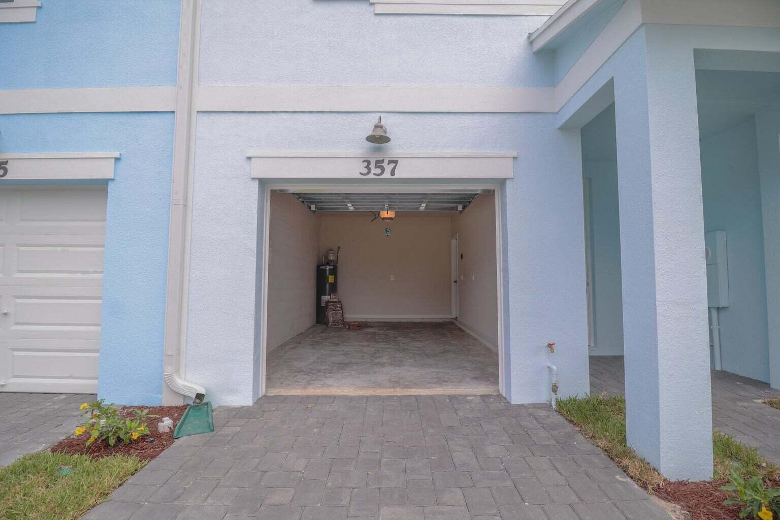 357 Southeast Angler Drive Stuart, FL 34994 - Photo 4 of 25 a view of a hallway with entryway and chandelier