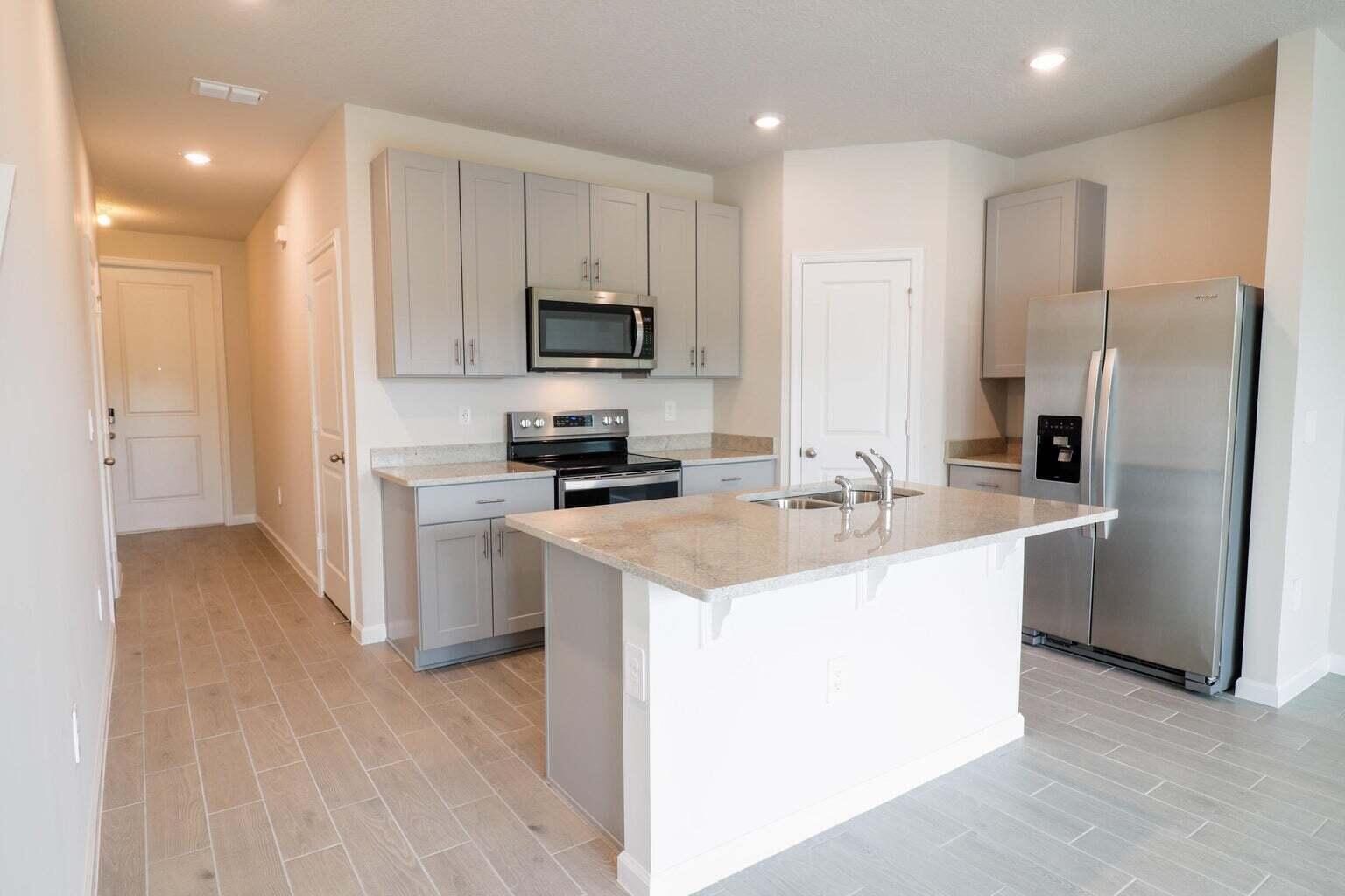 357 Southeast Angler Drive Stuart, FL 34994 - Photo 7 of 25 a kitchen with kitchen island a sink stainless steel appliances and cabinets