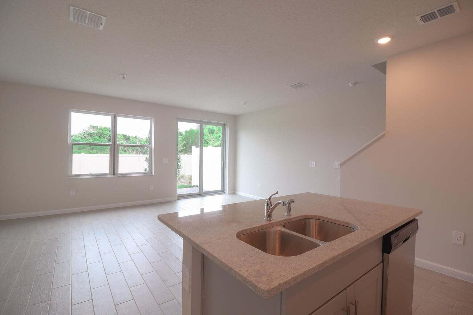357 Southeast Angler Drive Stuart, FL 34994 - Photo 10 of 25 a kitchen with a sink and a window