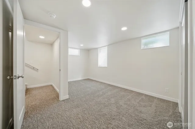 an empty room with windows and closet