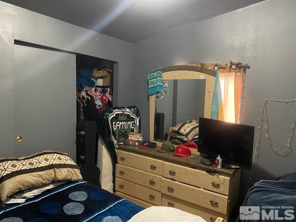 2127 Barberry Way Reno, NV 89512 - Photo 10 of 14 a bedroom with a bed and a couch