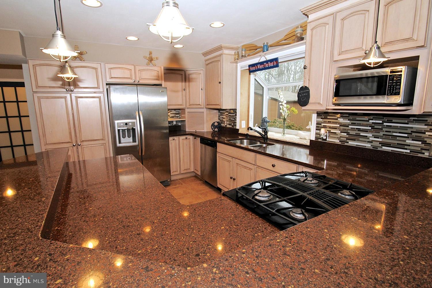 8366 Country Life Road Pasadena, MD 21122 - Photo 16 of 30 Pendant Lighting and Mosaic Tile Backsplash