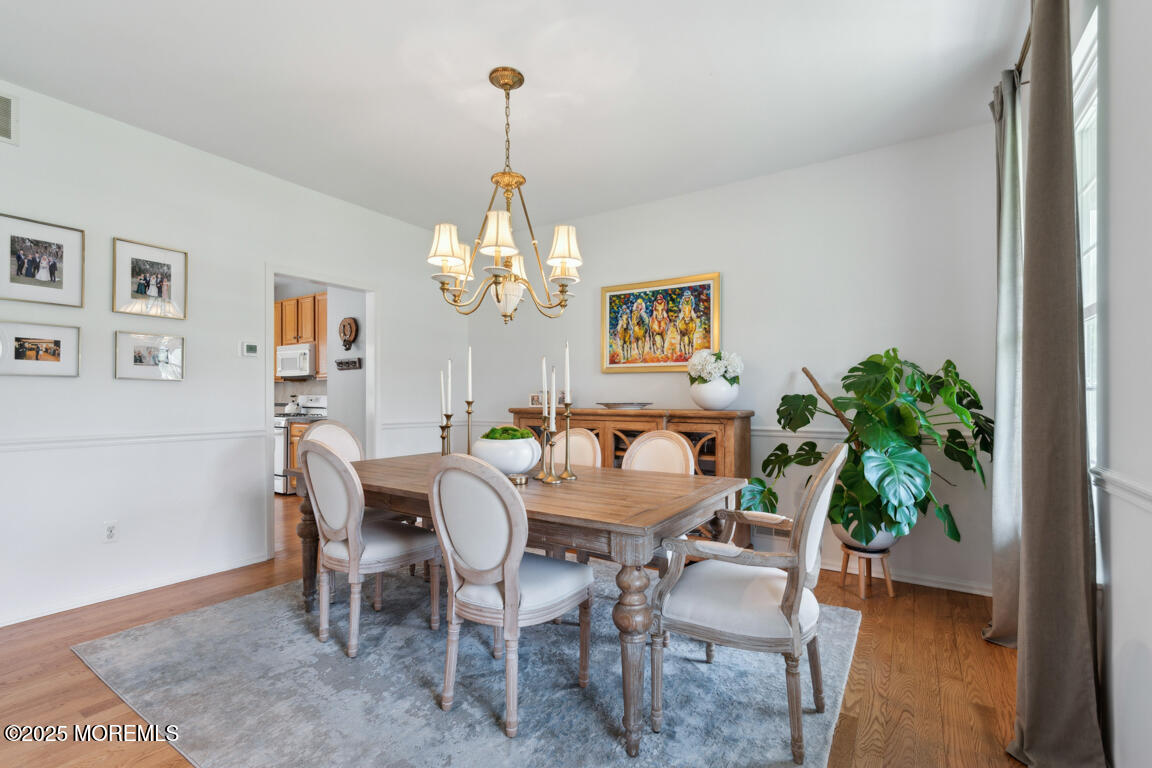 5 Trotter Way Cream Ridge, NJ 08514 - Photo 8 of 39 a view of a dining room with furniture wooden floor and a chandelier