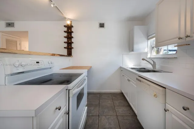 a kitchen with a sink and cabinets
