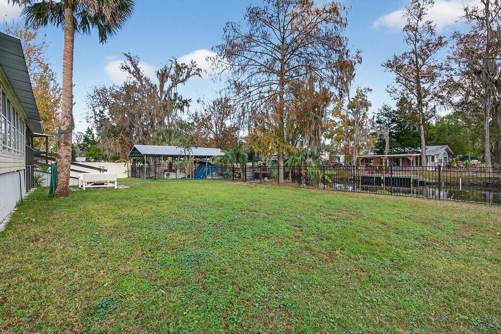 56320 Cherry Tree Road Astor, FL 32102 - Photo 20 of 40 a view of a house with a yard porch and sitting area