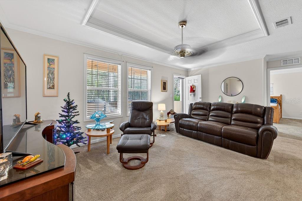 56320 Cherry Tree Road Astor, FL 32102 - Photo 28 of 40 a living room with furniture ceiling fan and a window
