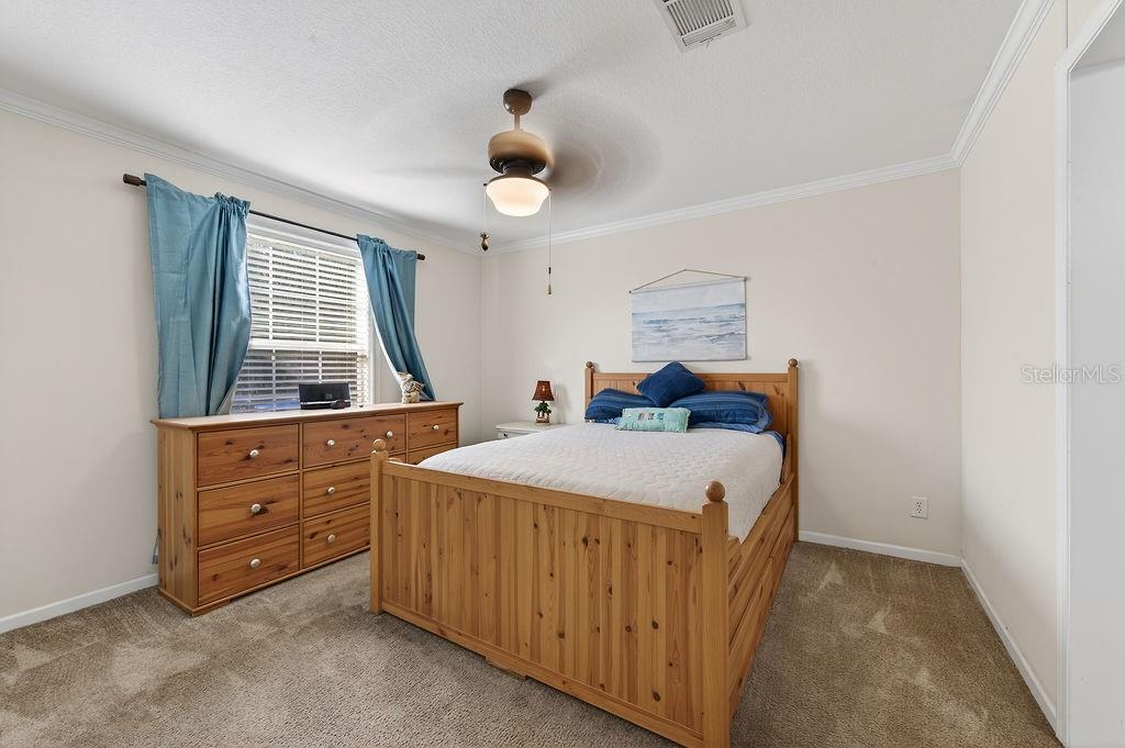 56320 Cherry Tree Road Astor, FL 32102 - Photo 34 of 40 a bedroom with a bed and a dresser