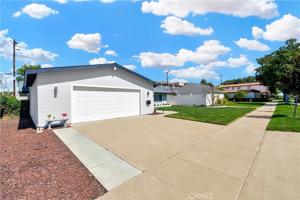 1543 East Fairway Drive Orange, CA 92866 - Photo 2 of 49 a front view of a house with a yard and garage