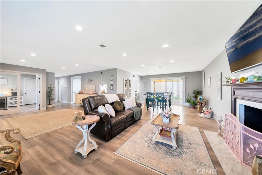 1543 East Fairway Drive Orange, CA 92866 - Photo 9 of 49 a living room with furniture a fireplace and a flat screen tv