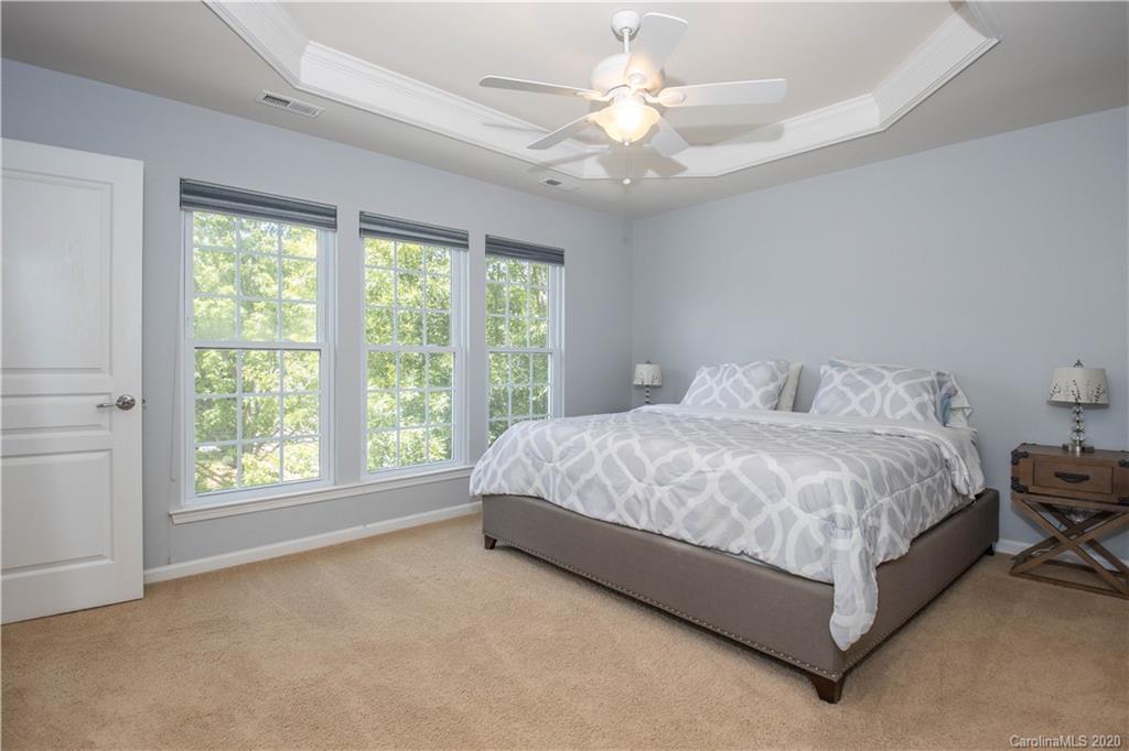 1068 Drayton Court Fort Mill, SC 29708 - Photo 13 of 37 a spacious bedroom with a large bed and a large window