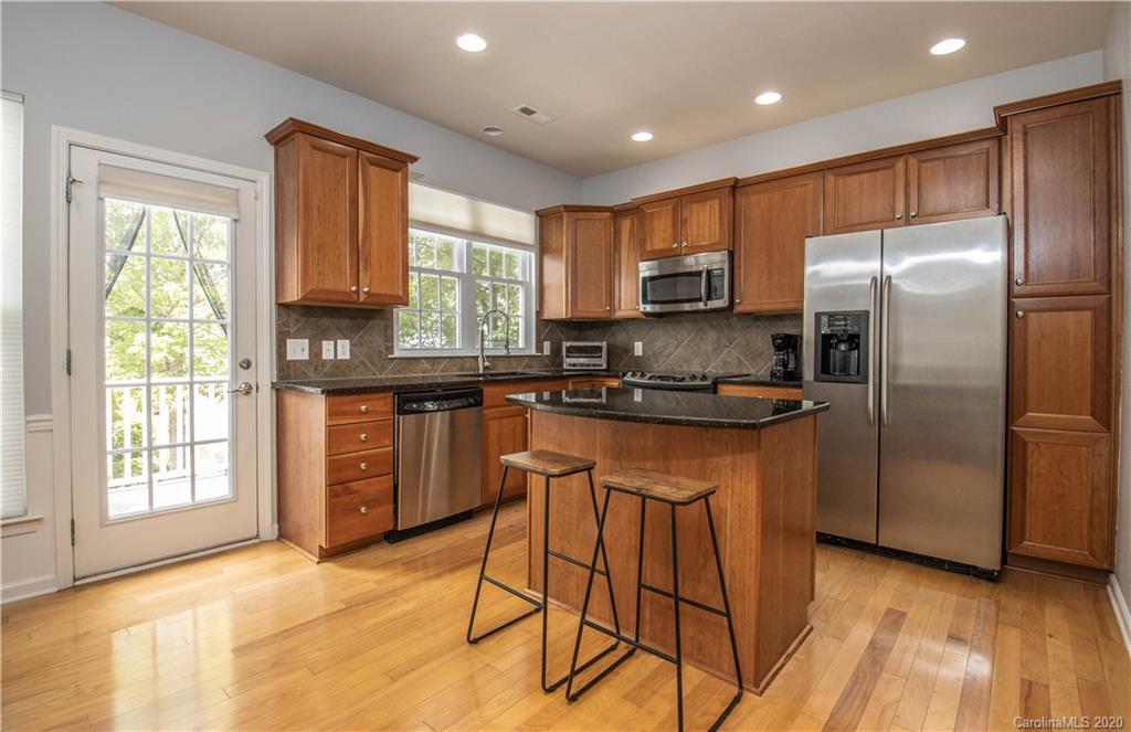 1068 Drayton Court Fort Mill, SC 29708 - Photo 8 of 37 a kitchen with stainless steel appliances granite countertop a refrigerator a sink a stove a microwave and cabinets