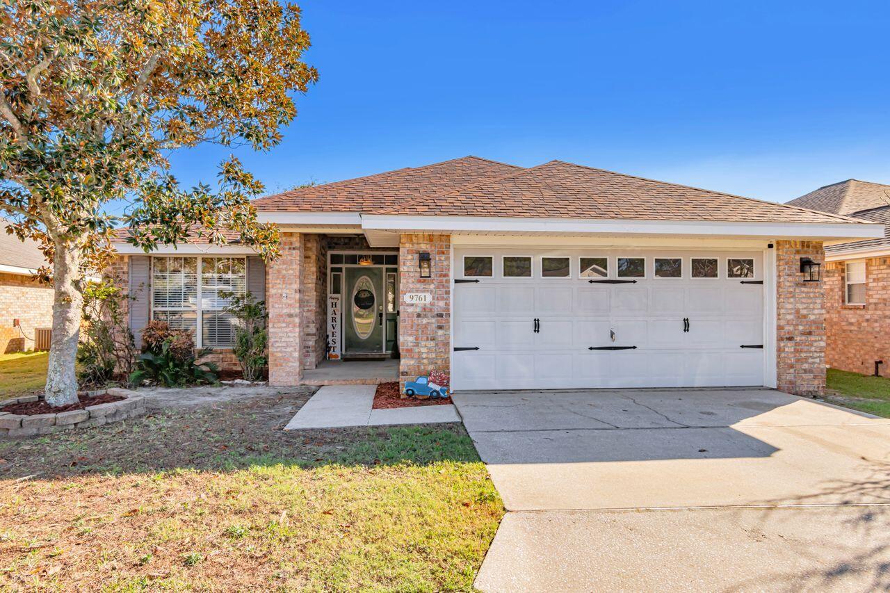 9761 Leeward Way Navarre, FL 32566 - Photo 1 of 43 a front view of a house with a yard
