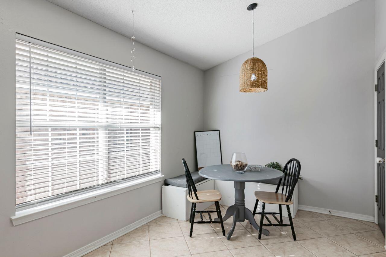 9761 Leeward Way Navarre, FL 32566 - Photo 14 of 43 a view of a dining room with a table and chairs