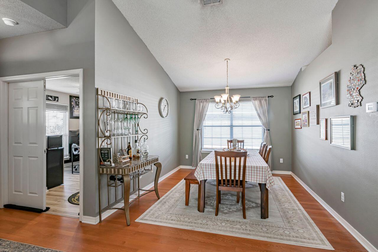 9761 Leeward Way Navarre, FL 32566 - Photo 16 of 43 a view of a livingroom with furniture window and wooden floor