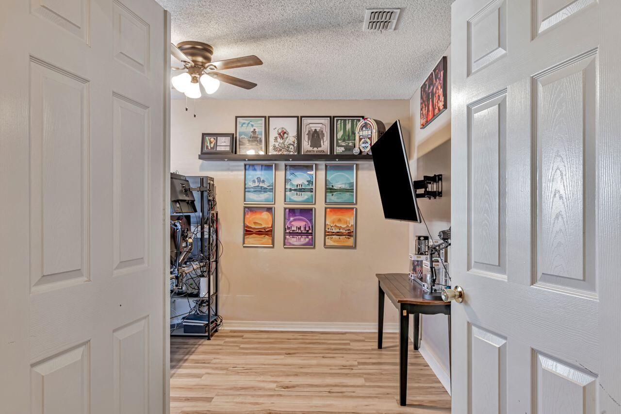 9761 Leeward Way Navarre, FL 32566 - Photo 19 of 43 wooden floor in an empty room with a window