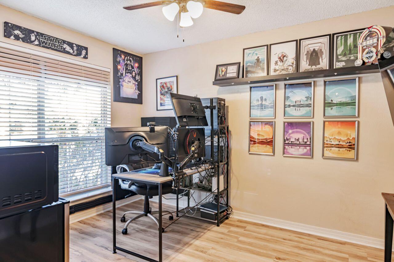 9761 Leeward Way Navarre, FL 32566 - Photo 20 of 43 a view of a workspace with furniture and a window