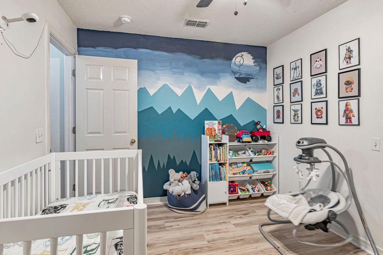 9761 Leeward Way Navarre, FL 32566 - Photo 22 of 43 a bedroom with furniture and a bed