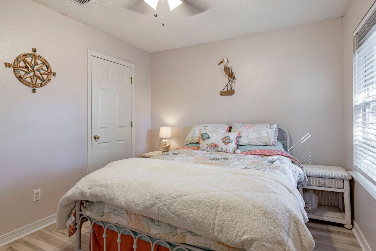 9761 Leeward Way Navarre, FL 32566 - Photo 28 of 43 a bedroom with a bed and a window