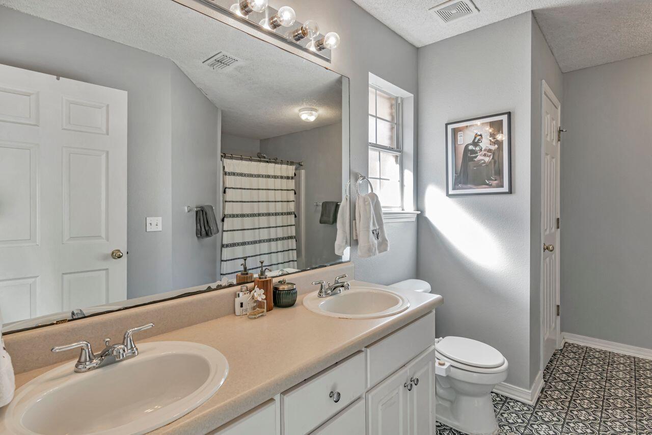 9761 Leeward Way Navarre, FL 32566 - Photo 29 of 43 a bathroom with a sink and a mirror