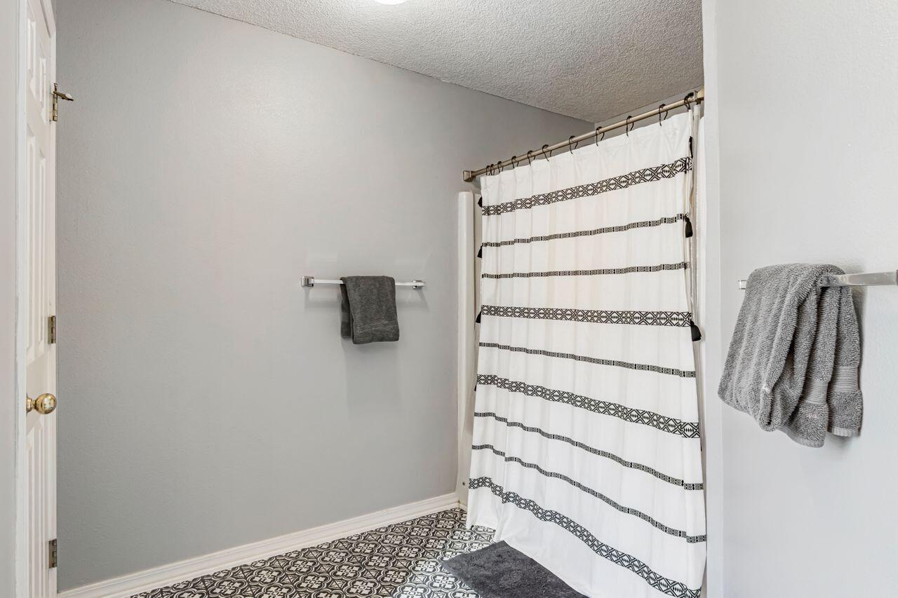 9761 Leeward Way Navarre, FL 32566 - Photo 30 of 43 a view of walk in closet with empty racks