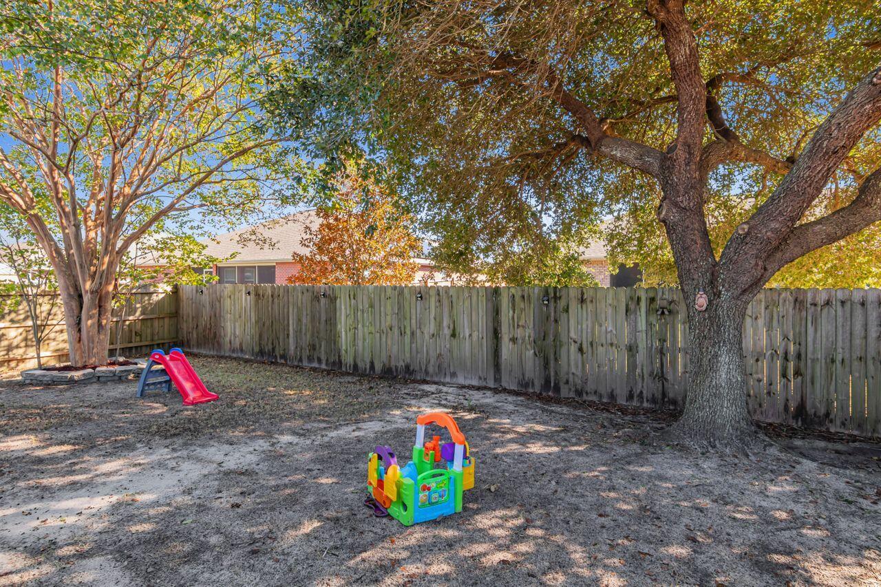 9761 Leeward Way Navarre, FL 32566 - Photo 34 of 43 a view of outdoor space with garden and entertaining space
