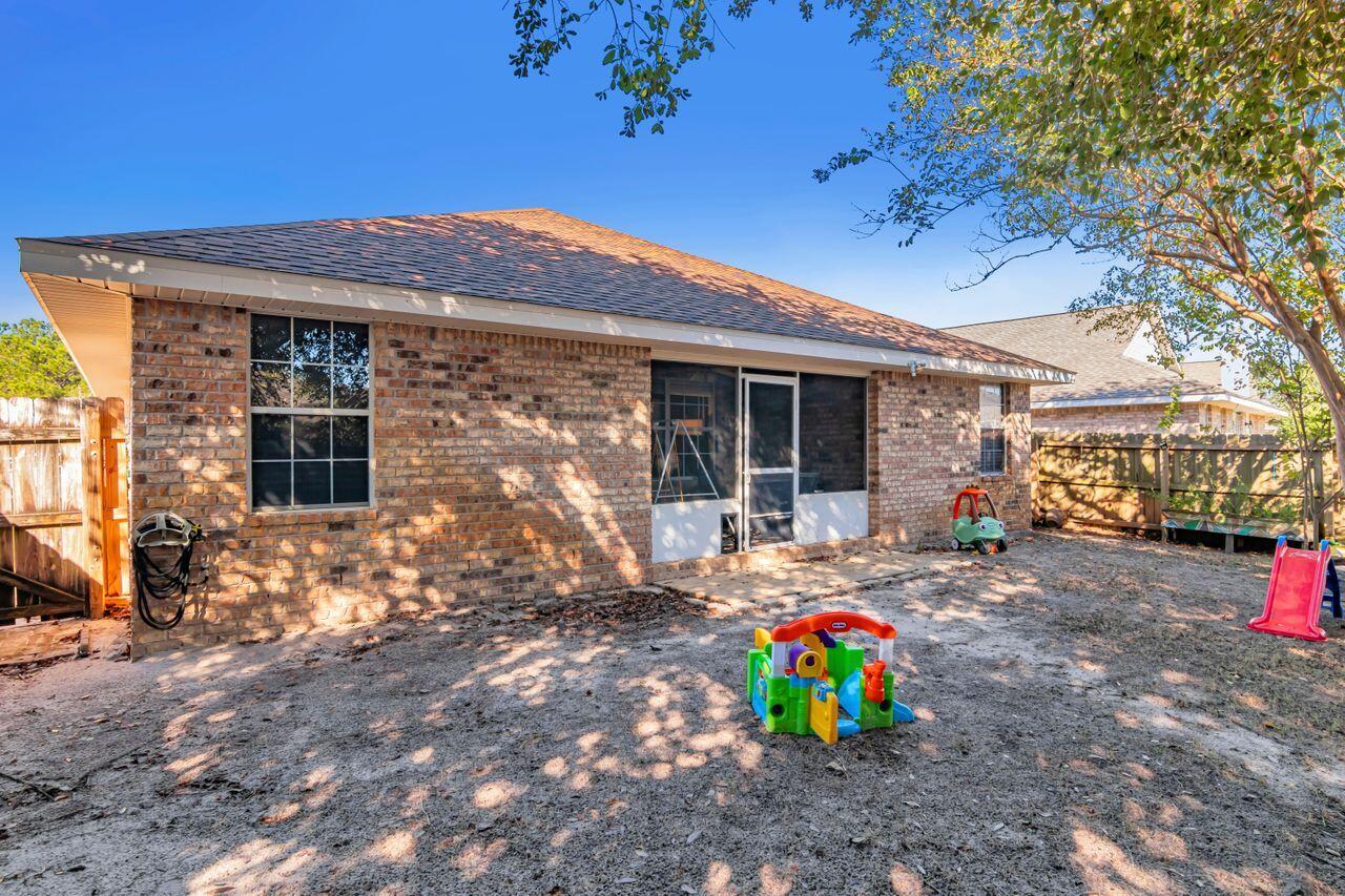 9761 Leeward Way Navarre, FL 32566 - Photo 35 of 43 a backyard of a house with seating space