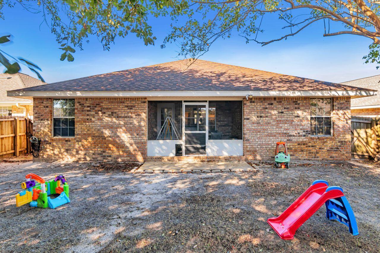 9761 Leeward Way Navarre, FL 32566 - Photo 36 of 43 a view of outdoor space patio and fire pit