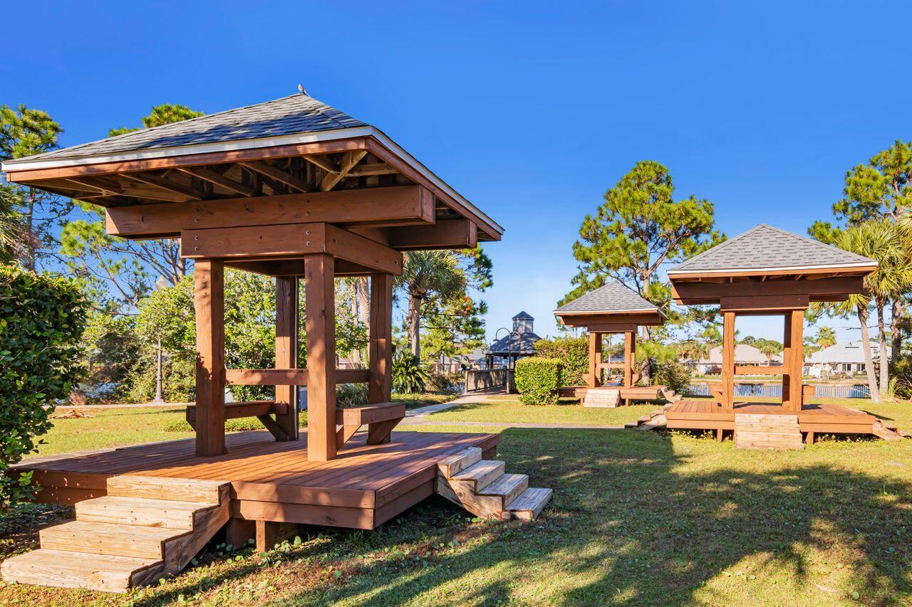 9761 Leeward Way Navarre, FL 32566 - Photo 39 of 43 a backyard of a house with barbeque oven table and chairs