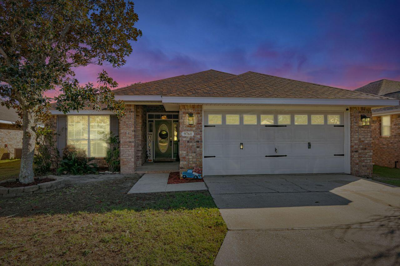 9761 Leeward Way Navarre, FL 32566 - Photo 43 of 43 a front view of a house with a yard