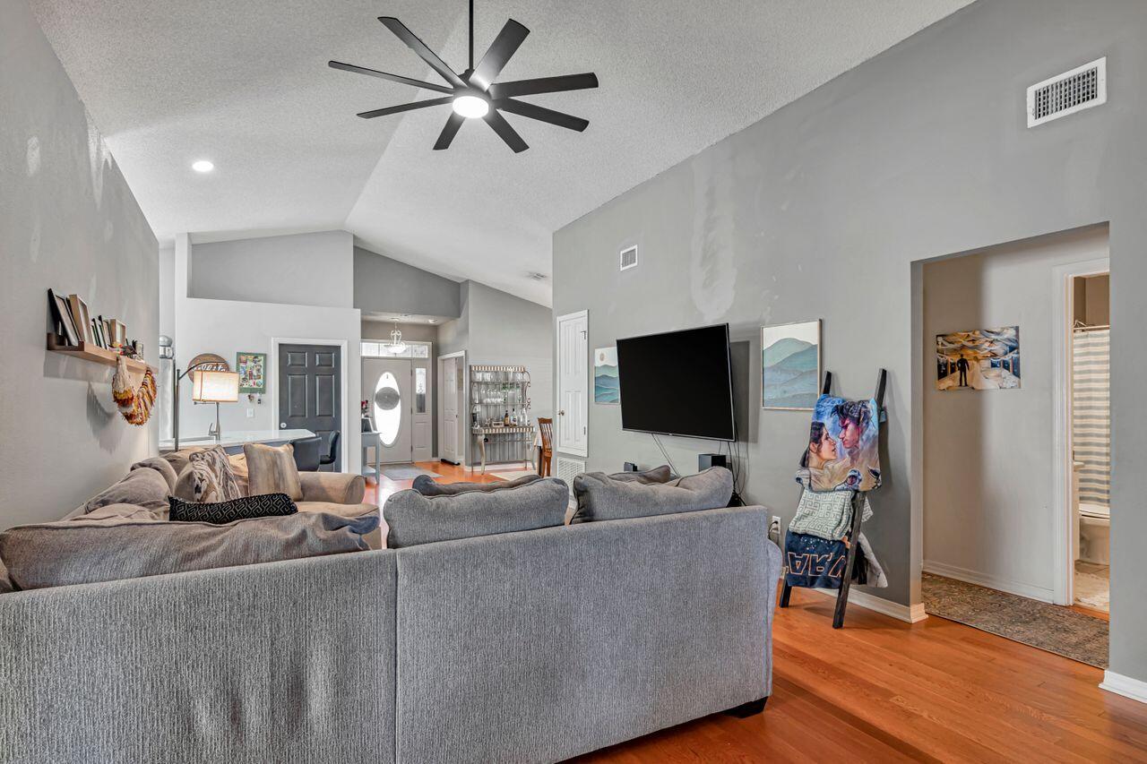 9761 Leeward Way Navarre, FL 32566 - Photo 6 of 43 a living room with furniture and a flat screen tv