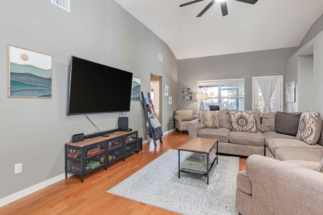 9761 Leeward Way Navarre, FL 32566 - Photo 7 of 43 a living room with furniture and a flat screen tv
