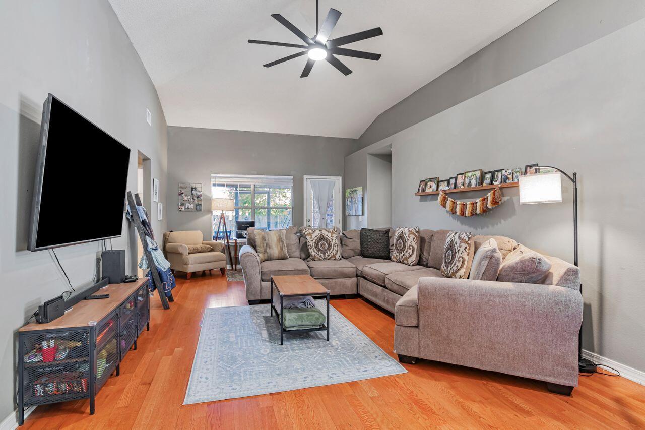 9761 Leeward Way Navarre, FL 32566 - Photo 8 of 43 a living room with furniture and a flat screen tv