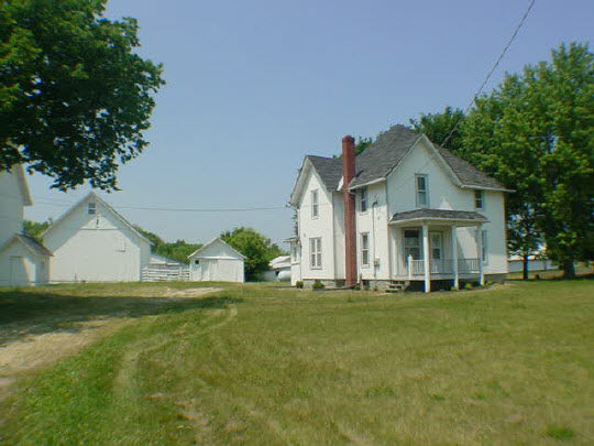 5937 River Road Cherry Valley, IL 61016 - Photo 1 of 1 a front view of a house with a garden and trees