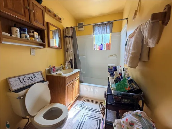 a bathroom with a toilet a sink and a mirror