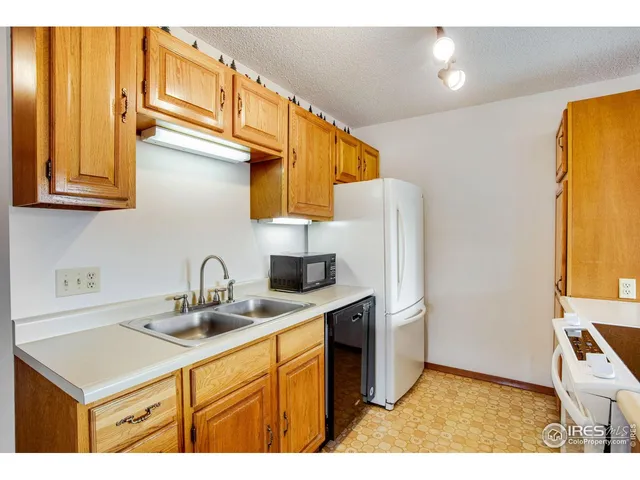 a kitchen with stainless steel appliances a sink and a refrigerator