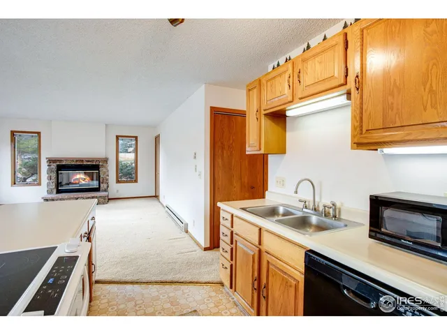 a kitchen with kitchen island a sink stove and microwave