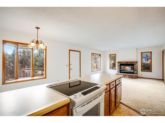 a kitchen with granite countertop a stove and a sink